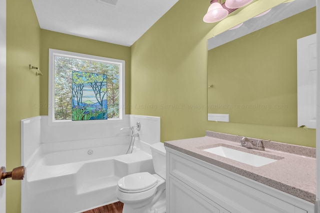 full bathroom featuring visible vents, toilet, vanity, and a bath