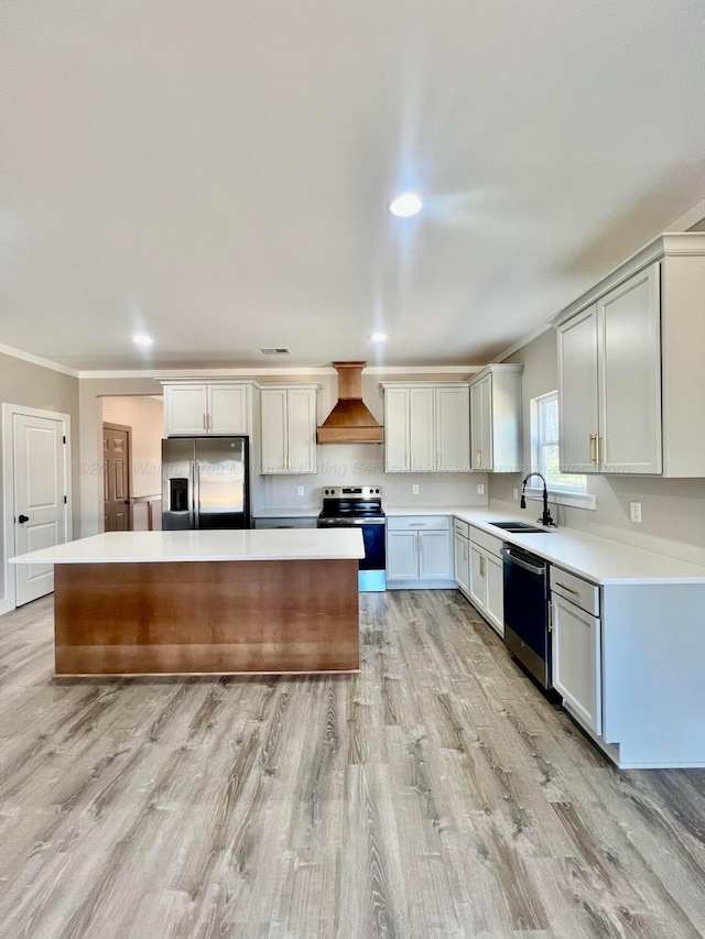 kitchen featuring a kitchen island, custom exhaust hood, ornamental molding, a sink, and appliances with stainless steel finishes