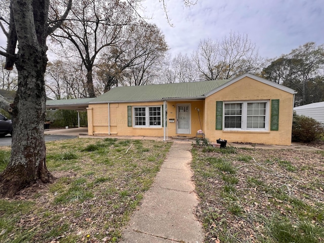 2514 15th Ave, Haleyville, AL 35565 - view of front of house featuring metal roof, an attached carport, concrete block siding, and brick siding