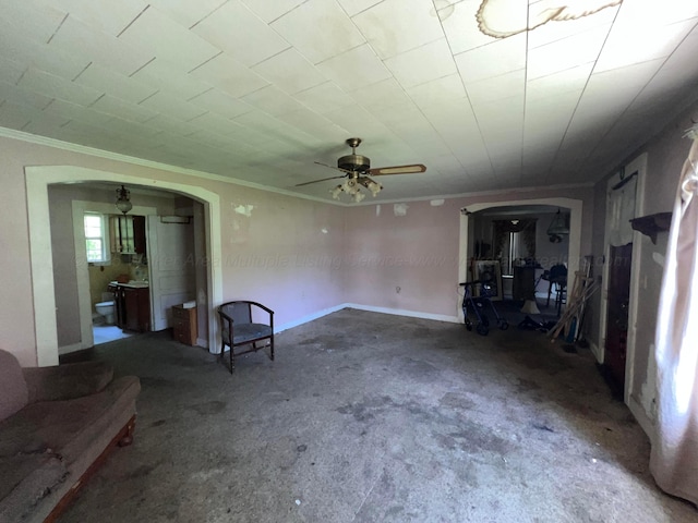 2514 15th Ave, Haleyville, AL 35565 - unfurnished living room featuring arched walkways, ornamental molding, and a ceiling fan