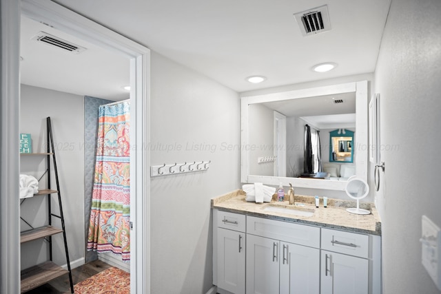 bathroom featuring vanity and wood finished floors