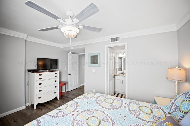 bedroom featuring dark wood-style floors, baseboards, crown molding, ensuite bathroom, and ceiling fan