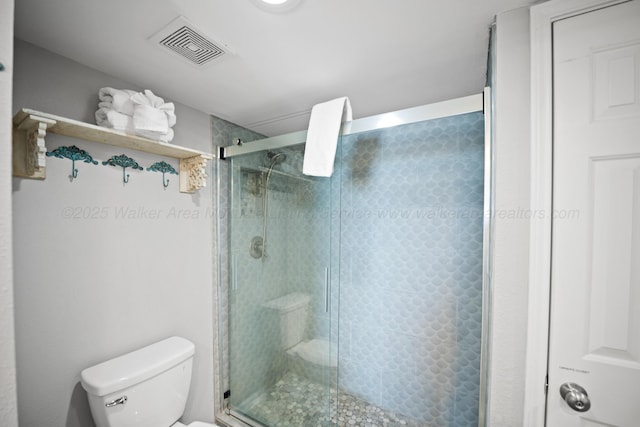 full bathroom with toilet and a shower stall