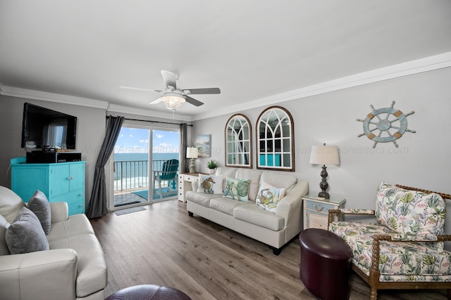 living room with ornamental molding, ceiling fan, and wood finished floors