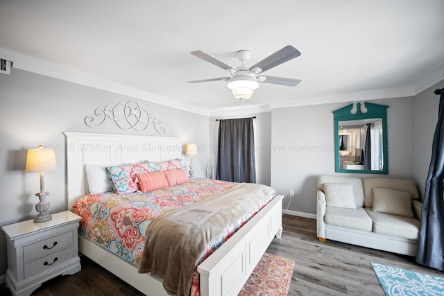 bedroom featuring crown molding, dark wood-type flooring, a ceiling fan, and baseboards
