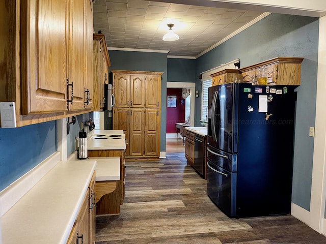kitchen featuring dark wood-style flooring, light countertops, black appliances, and crown molding