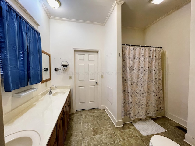 full bathroom with toilet, a sink, baseboards, ornamental molding, and double vanity