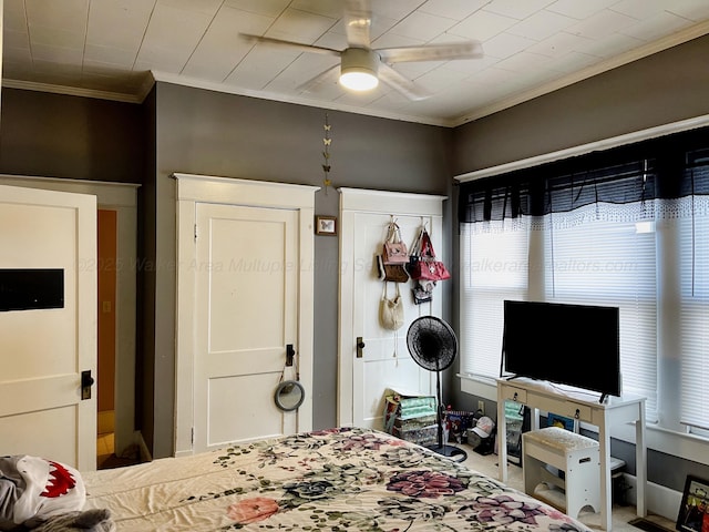 bedroom featuring a ceiling fan and crown molding
