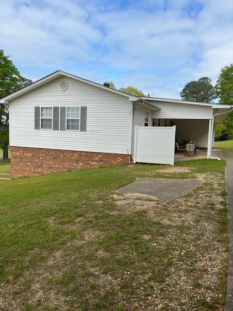 915 County Highway 4, Winfield, AL 35594 - rear view of house featuring a carport and a yard
