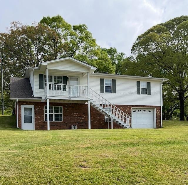 915 County Highway 4, Winfield, AL 35594 - back of property with stairway, a lawn, a porch, a garage, and brick siding