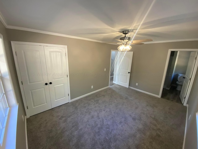 unfurnished bedroom with a closet, crown molding, carpet, and baseboards