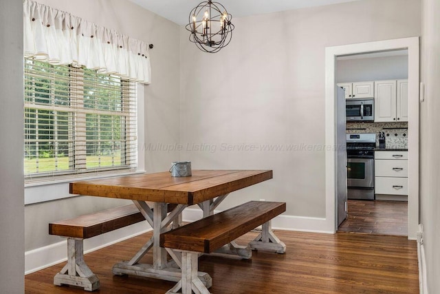 dining room with an inviting chandelier and dark hardwood / wood-style flooring