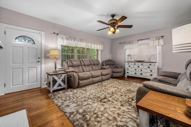 living room with wood-type flooring and ceiling fan