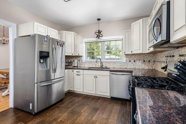 kitchen featuring white cabinetry, stainless steel appliances, dark hardwood / wood-style flooring, and sink