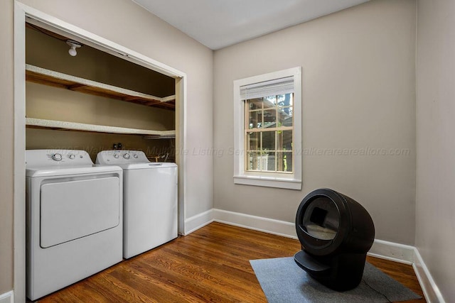 laundry area featuring dark wood-type flooring and washing machine and dryer