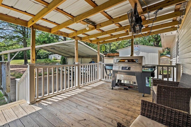 deck with a carport and a grill