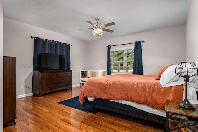 bedroom featuring radiator heating unit, wood-type flooring, and ceiling fan