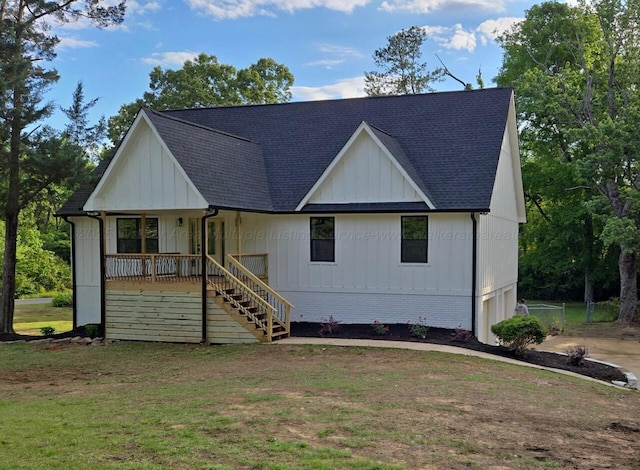 modern inspired farmhouse with board and batten siding, covered porch, stairway, roof with shingles, and a front lawn