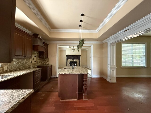 1068 Old Zion Loop, Nauvoo, AL 35578 - kitchen featuring a fireplace, tasteful backsplash, a raised ceiling, ornamental molding, and light stone counters