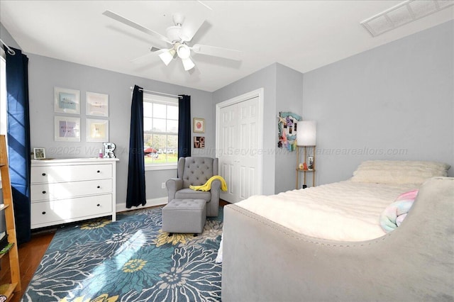 bedroom with a closet, visible vents, a ceiling fan, and wood finished floors