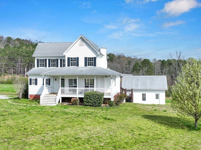 view of front of property with a chimney, a front lawn, and a porch