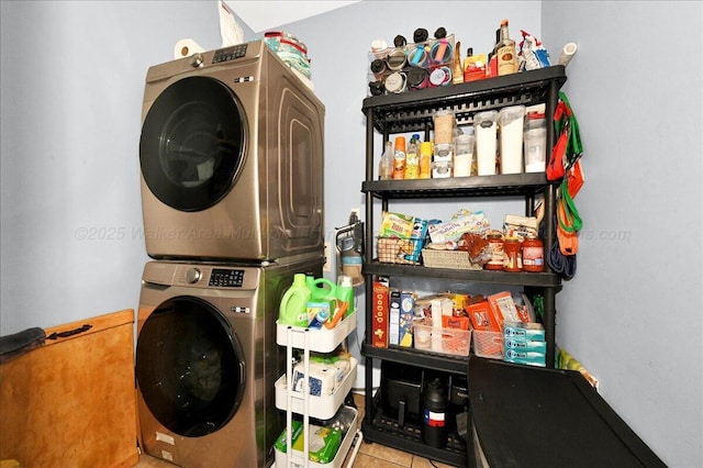 laundry area featuring stacked washer and clothes dryer and laundry area