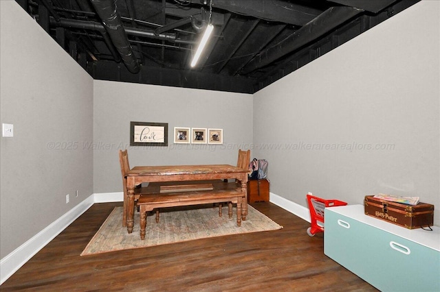 dining space featuring baseboards and wood finished floors
