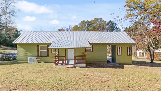 back of house with crawl space, metal roof, ac unit, and a yard
