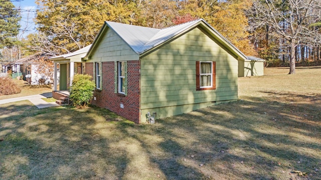 view of side of property with crawl space, a yard, and metal roof