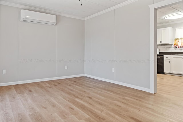 unfurnished room with light wood-style flooring, a wall mounted AC, and ornamental molding