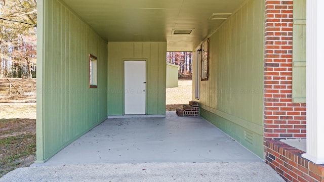 property entrance featuring an attached carport and visible vents