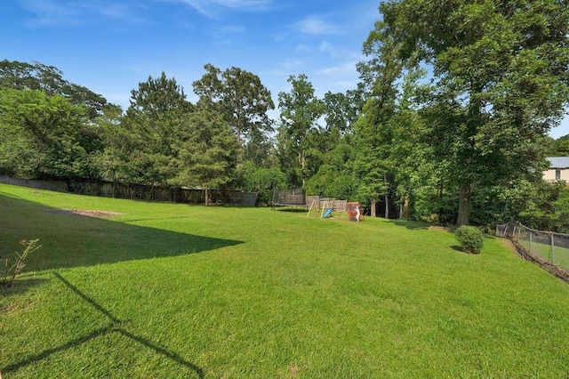 805 3rd Ave, Jasper, AL 35501 - fenced backyard featuring a playground and a trampoline