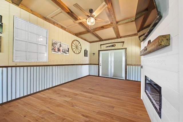 805 3rd Ave, Jasper, AL 35501 - empty room featuring coffered ceiling, wood finished floors, a glass covered fireplace, beamed ceiling, and ceiling fan