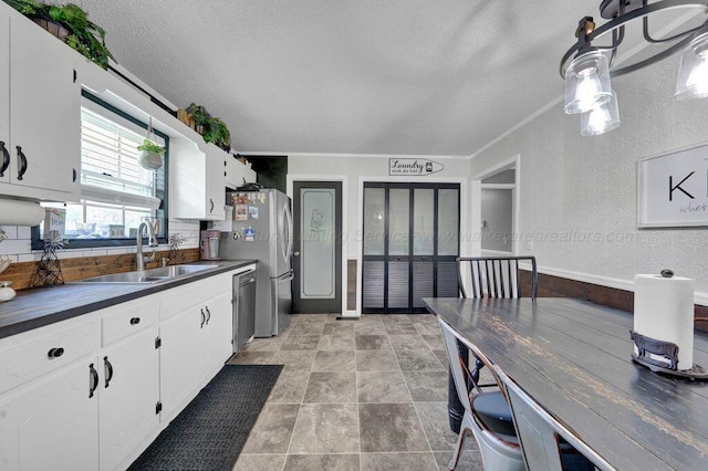 805 3rd Ave, Jasper, AL 35501 - kitchen featuring dark countertops, appliances with stainless steel finishes, a textured ceiling, white cabinetry, and french doors