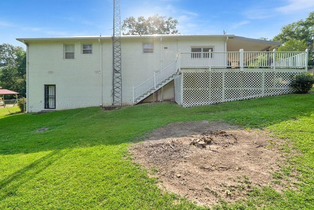 805 3rd Ave, Jasper, AL 35501 - back of property with a wooden deck, a yard, brick siding, and stairs