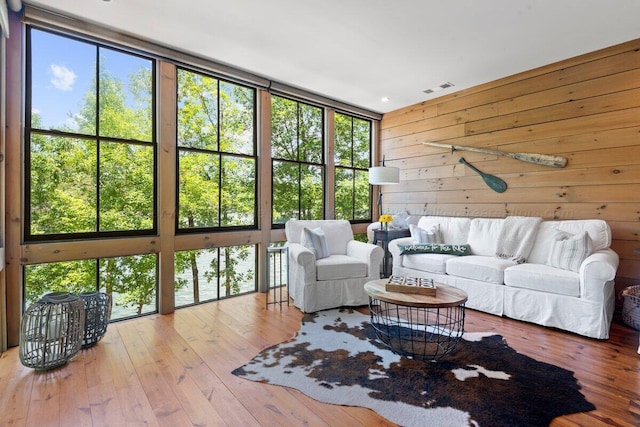 134 Turtle Point Dr, Crane Hill, AL 35053 - living area with plenty of natural light, hardwood / wood-style floors, and wooden walls