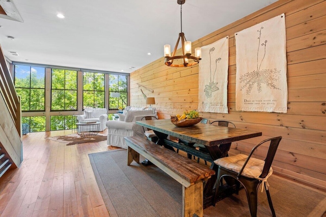 134 Turtle Point Dr, Crane Hill, AL 35053 - dining room with wood walls, a chandelier, hardwood / wood-style flooring, recessed lighting, and expansive windows