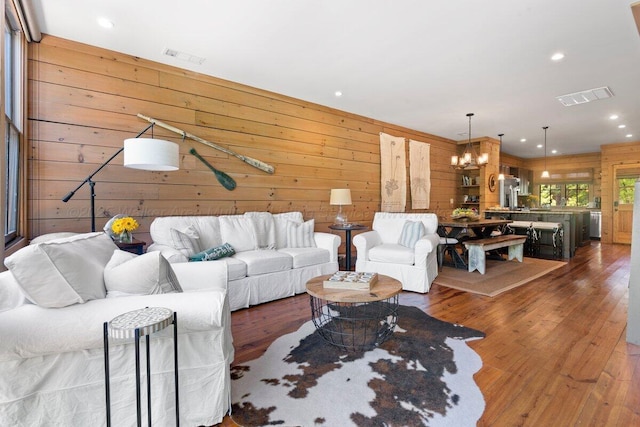 134 Turtle Point Dr, Crane Hill, AL 35053 - living area with wooden walls, wood finished floors, a chandelier, and recessed lighting