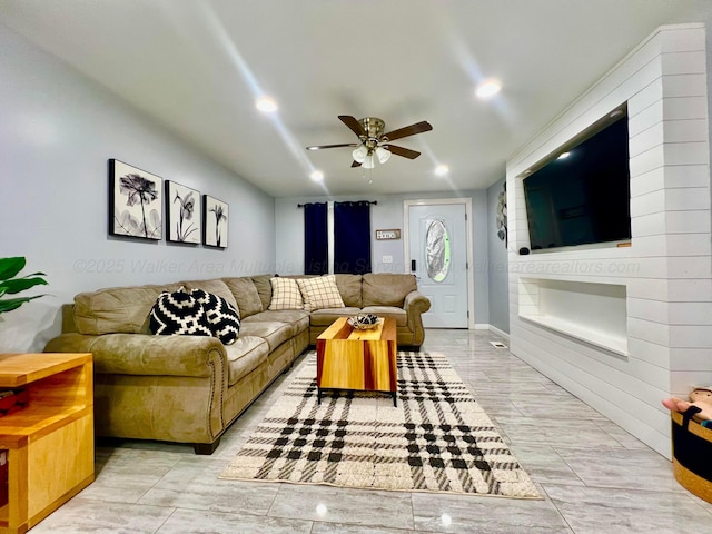 living room featuring a ceiling fan and recessed lighting