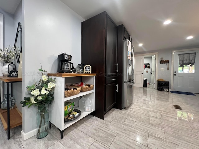hall featuring baseboards and recessed lighting