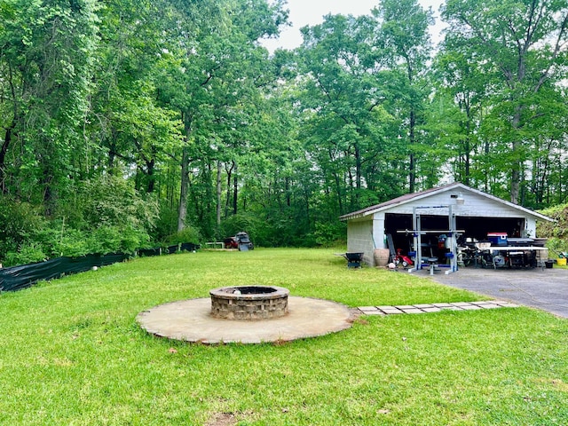 view of yard featuring a fire pit and an outbuilding