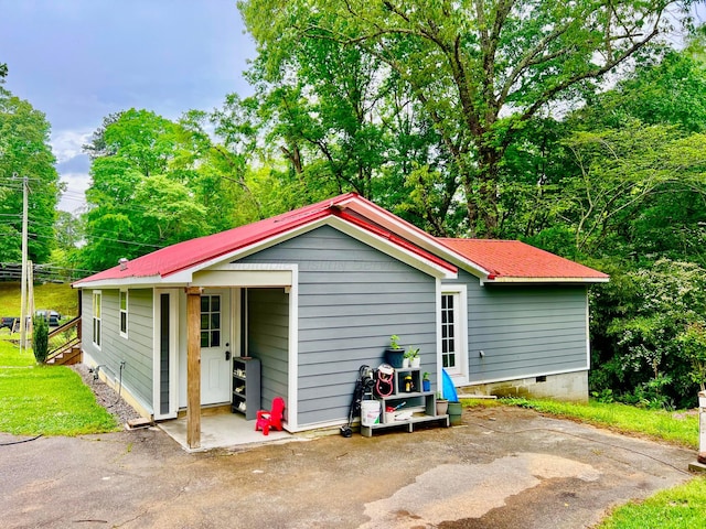 exterior space featuring metal roof and crawl space