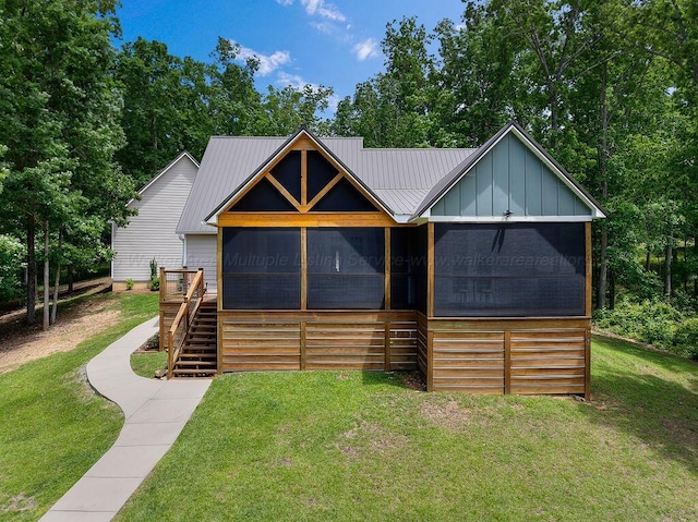 1433 Sipsey Pines Rd, Arley, AL 35540 - view of front of property featuring a sunroom, a front yard, board and batten siding, stairway, and metal roof