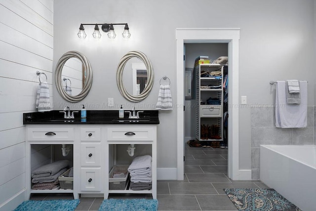 1433 Sipsey Pines Rd, Arley, AL 35540 - bathroom with tile patterned flooring, double vanity, a bathtub, and a walk in closet