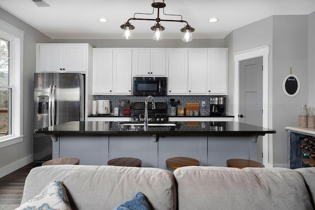 1433 Sipsey Pines Rd, Arley, AL 35540 - kitchen featuring open floor plan, black appliances, baseboards, tasteful backsplash, and white cabinets