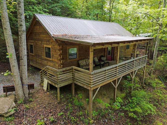 back of house featuring metal roof
