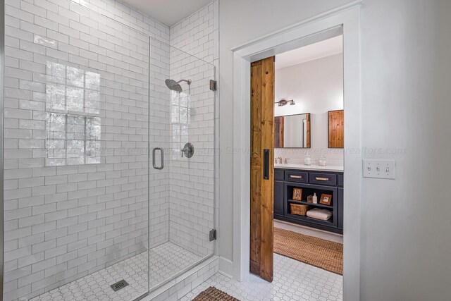 bathroom with vanity, tile patterned floors, a shower with door, and backsplash