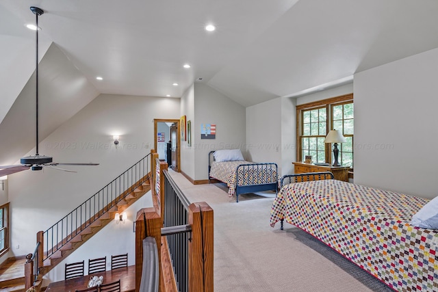 bedroom featuring ceiling fan, light hardwood / wood-style flooring, and lofted ceiling