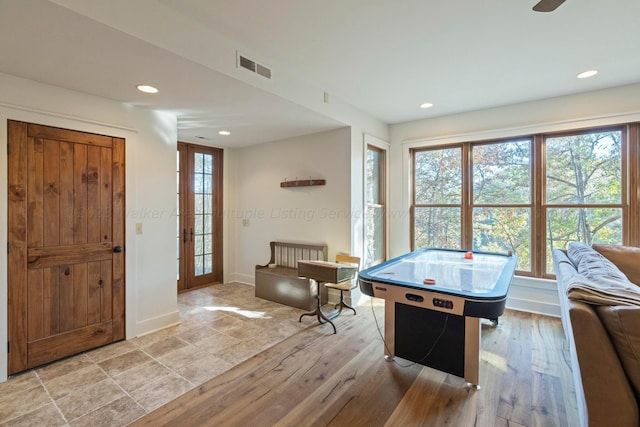 game room with light hardwood / wood-style floors