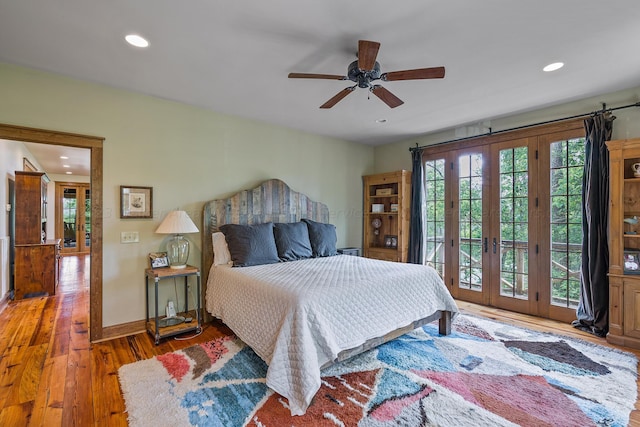 bedroom featuring ceiling fan, dark wood-type flooring, access to outside, and french doors